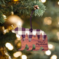 Wooden bear ornament with plaid pattern and 'Merry Christmas' text hanging on a Christmas tree.